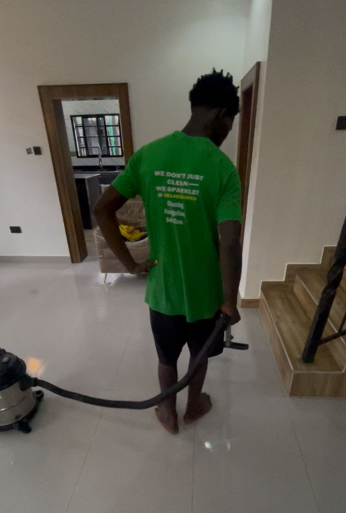 Sparkhives staff in green branded shirt vacuuming commercial and office space
